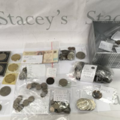 A box containing assorted used circulated coinage and some commemorative packs.