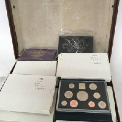 A leather case containing approximately 27 collection of proof annual decimal sets from 1970-1990 with some doubles and other coinage including silver 1977 crown and others, including &#20132660835.00 sets