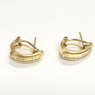 A pair of 18ct gold and diamond clip / stud earrings. 4.12g