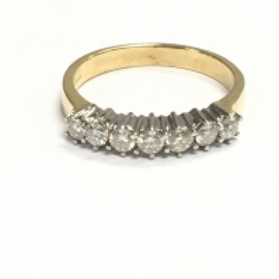 An 18ct gold diamond seven stone ring. Size M 1/2 and 3.71g Postage A