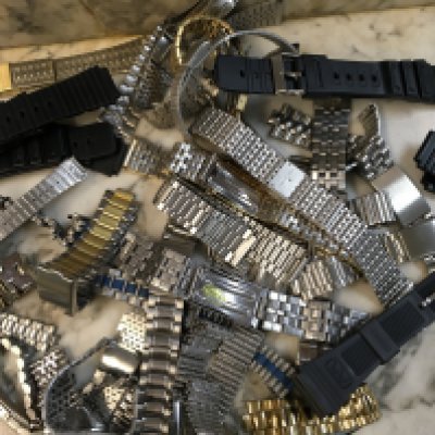 A Collection of various watch straps.together with time pieces.