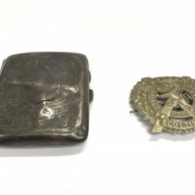 A silver cigarette case and London Scottish regiment cap badge. Postage B
