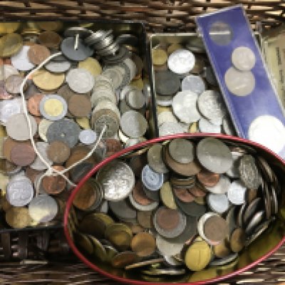 Three tins of assorted foreign coinage.