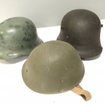 A German I world war M16 helmet a German Third Reich M-42 helmet and an unusal British Military issue light weight Merit plastic helmet (3)