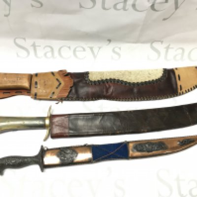 Three Swords including a German hunting knife (60cm long) and a Cuban souvenir machete (59cm long approximately).