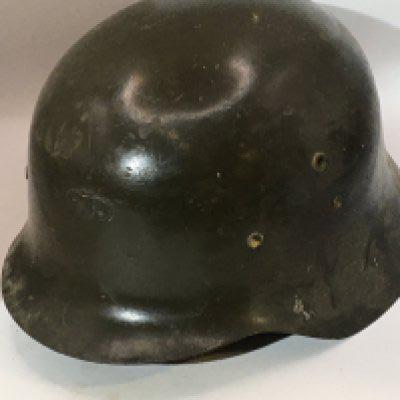 A German Third Reich M42 pattern helmet green with attached bracket above the peak thick cut leather liner. No obvious stamp marks.
