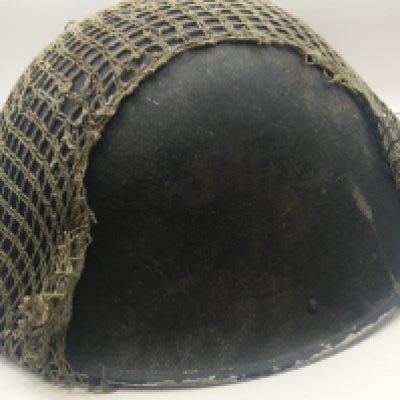 A British Military post Second World War helmet with netting cover and fitted with interior helmet lining. NO RESERVE