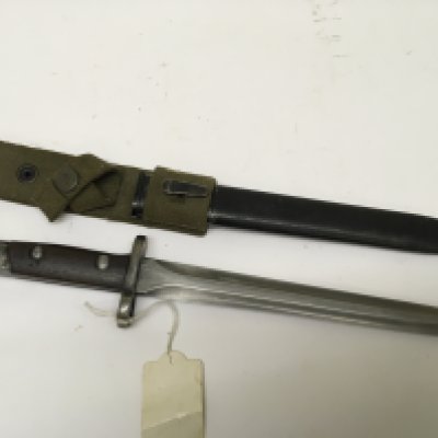 A German Imperial Colonial overseas forces bayonet S71/84 with a wood and steel grip stamped SA30 with a green canvas frog metal scabbard. Length 38cm
