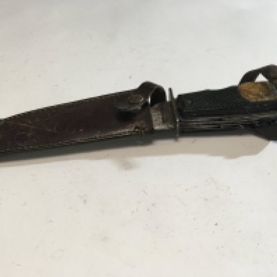 An interesting Vintage German Solingen multi functional knife with steel blade and makers stamp in a leather scabbard.