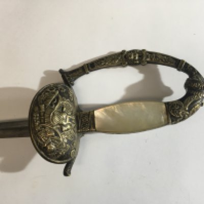 A Court sword possible Italian with mother of pearl grip with ornamentation of Roman influence and patterned blade.