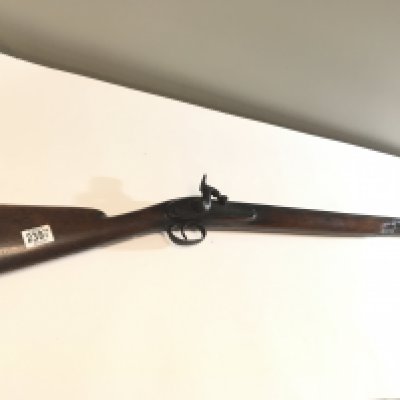 A 19th century Percussion Rifle with half length walnut stock long barrel with ram rod no maker marks. functional action