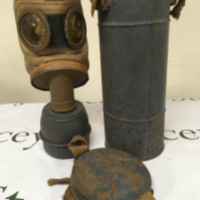 A II world war gas mask within a painted metal canister possible German Third Reich allied forces the base stamped TS-54-39.