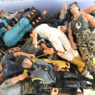 A Box Comtaining A Collection Of Modern Action Men With Accessories.