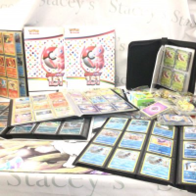 A large collection of modern Pok&eacute;mon cards many in albums or in sealed packs includes dice etc.