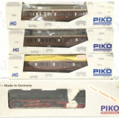 A Boxed H0 Gauge Piko Locomotive And 3 Boxed Coaches.