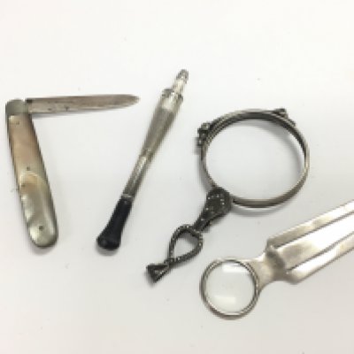 A silver hallmarked pen knife, silver book mark, silver lorgnettes and a silver cigarette holder. Postage category A