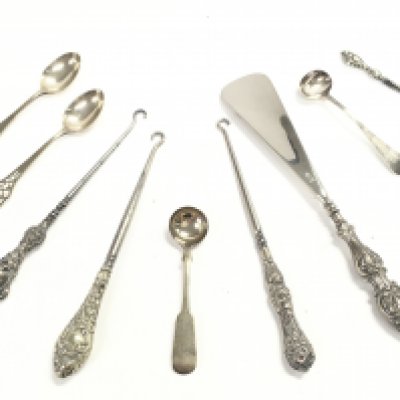 A Collection of silver hallmarked items including button hooks, spoons