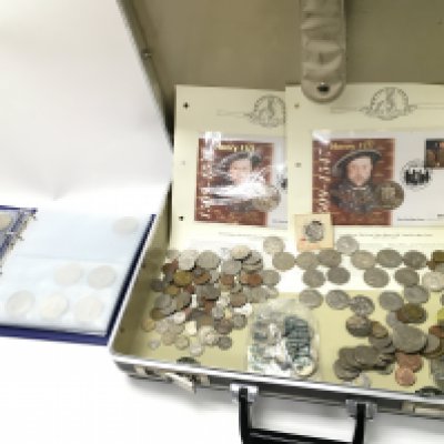 A collection of world coinage including US Canadian etc. Including two first day covers and a chick fil A bicentennial quarter.