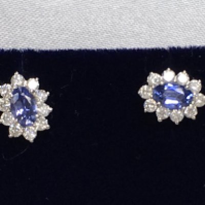 Pair of 18ct white gold oval sapphire and RBC diamond cluster studs, boxed. Sapphires 0.66ct. Diamonds 0.44ct. Postage category A.