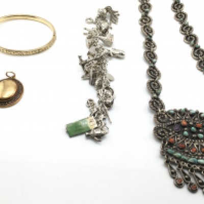 Silver charm bracelet along with Mexican silver necklaces and a yellow metal bracelet and brooch. Postage B