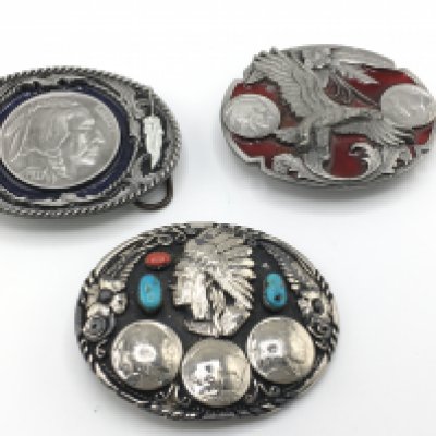 A collection of three belt buckles including two Siskiyou examples set with American coins and another set with turquoise and coral. Postage B