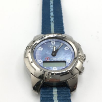 A Tissot Touch wrist watch with a mother of pearl dial and blue canvas strap and titanium case. Needs new battery. 42mm case. Postage B