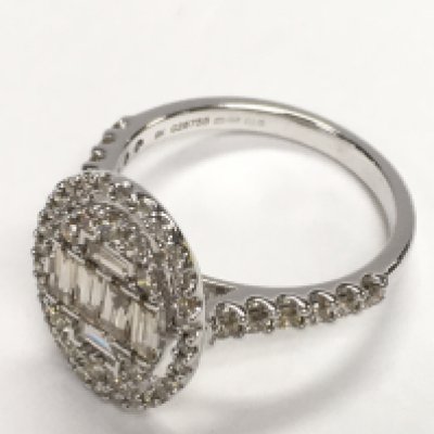 Large oval cluster ring set with baguette cut and round brilliant cut diamonds with diamond shoulders, set in 9ct white gold. Diamonds 1.06ct. Postage category A. Ring size Approx M/N.