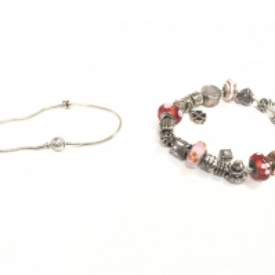 A silver Pandora bracelet and a silver Pandora charm bracelet with the majority of charms also being Pandora. Postage category A