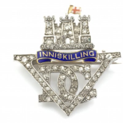 A Diamond and enamel regimental brooch depicting the 5th Inniskilling dragoon guard. Approx 3cm wide.Postage A