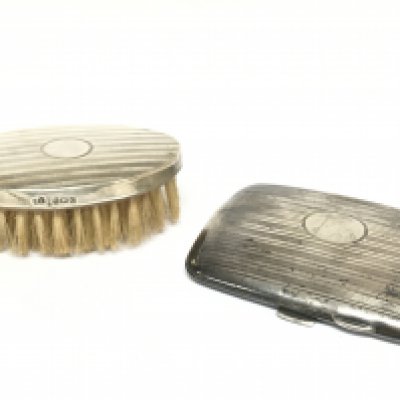 A silver hallmarked cigarette case and a hand brush. Postage category B