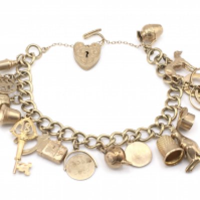 A 9ct gold charm bracelet with multiple charms.34.19g.Postage A