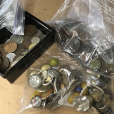 A collection of various coinage and a bag of military buttons