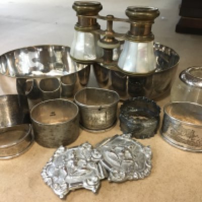 A collection of six napkin rings including silver together with an Indian white metal buckle, a pair of opera glasses, two silver white metal bowls and a glass match holder with silver rim
