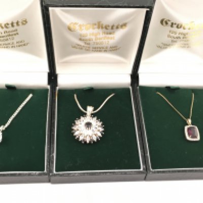 Three pendants on chains including 1 9ct gold example (2.46g) and two silver ones. Postage B