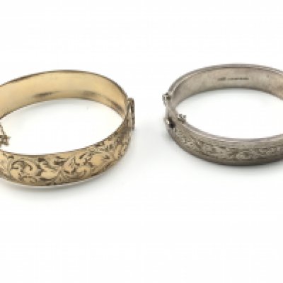 A gold core bangle and a silver bangle. Postage B