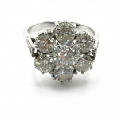 WITHDRAWN - A Quality diamond cluster and platinum ring set with six round old cut diamonds in a floral pattern the shank set with smaller diamonds. each diamond approximately 0.25 -0.35 of a carat total carat weight approximately 1.5carat colour grade I/J clarity SI2. Total weight 4.5g ring size M. Sold with independent Gemologists Report.