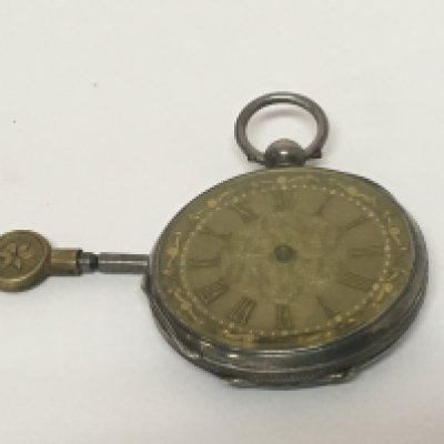 A silver cased key wind pocket watch with a key for restoration.