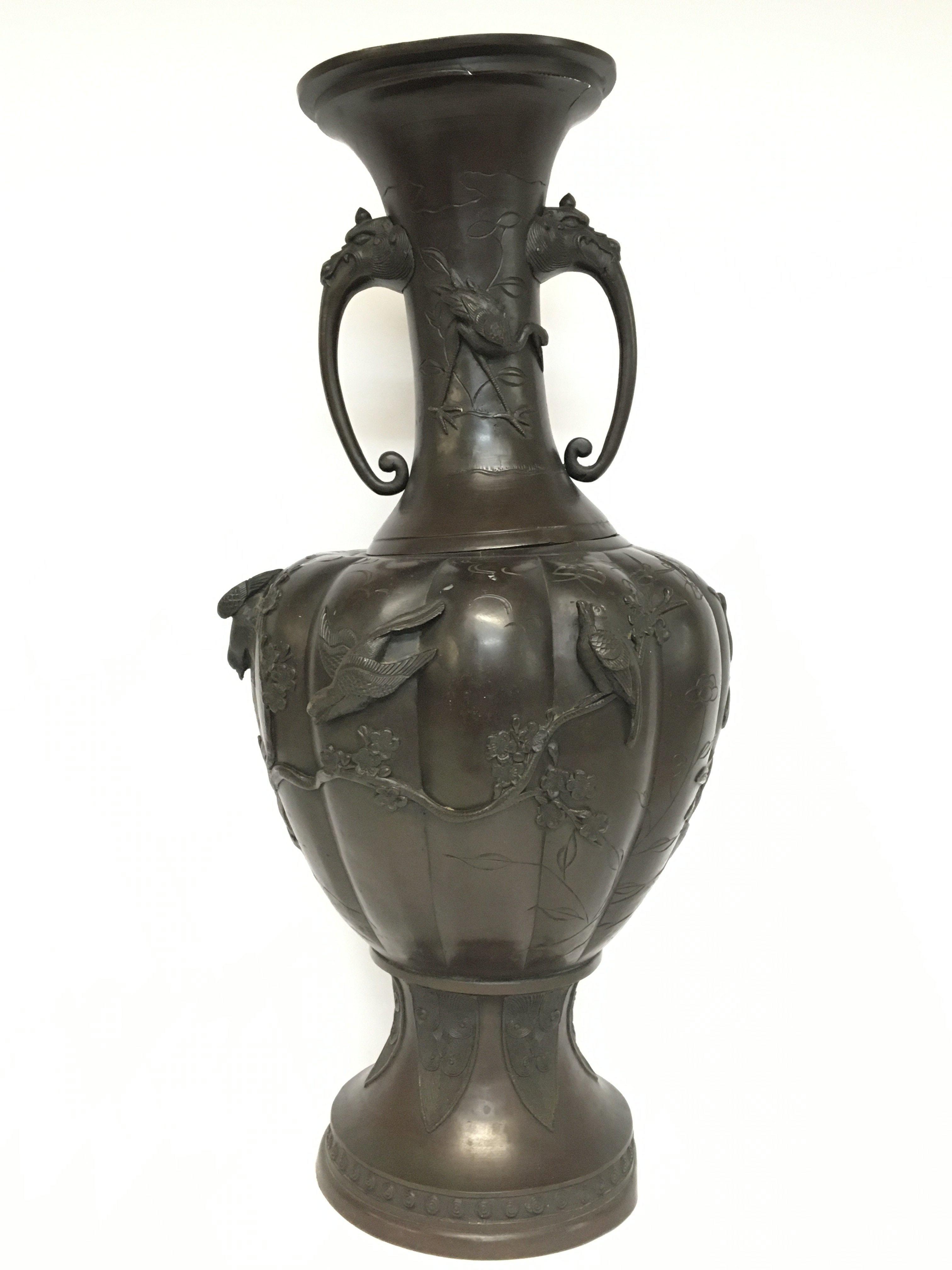 A Japanese bronze vase decorated with cherry blossom trees & Bush Warblers with damage. 60cm tall. Postage cat D