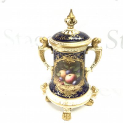 A Coalport porcelain vase with lid. Showing a painted panel of fruit. Approximately 25cm tall.