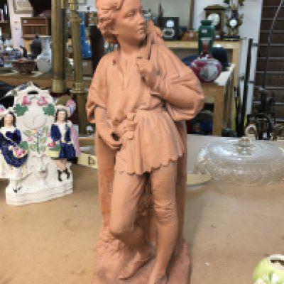 A terracotta figurine stamped art Union of London. 53cm tall.
