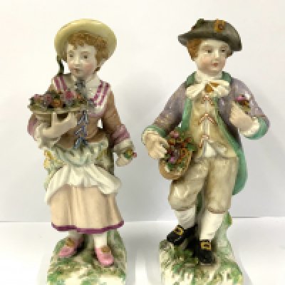 A pair of Sitzendorf porcelain figures of a boy and girl flower seller. 14.5cm. NO RESERVE