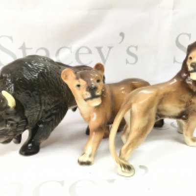 Three ceramic animals including West German Made lions and a Melba Ware buffalo . This lot cannot be posted