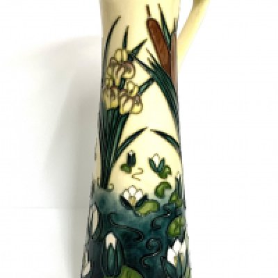 A modern Moorcroft, Lamia pattern jug designed by Rachel Bishop, the cream ground decorated with flowers, dated '95, impressed marks 23cm