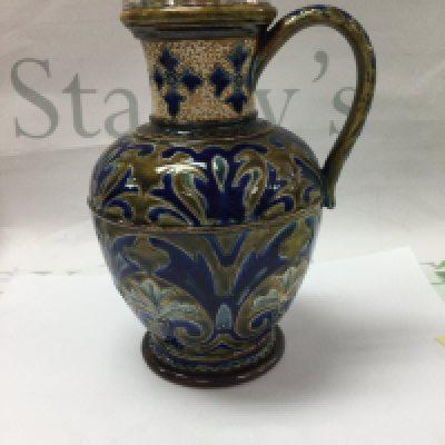 A Victorian Doulton Lambeth jug decorated with floral design with silver Plated rim 20 cm .