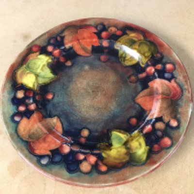 A Moorcroft Flambe leaf and berry plate. 23cm diameter. Good condition