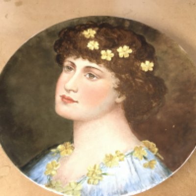 Moore & Co late 19th century charger in the arts and crafts style decorated with a hand painted portrait of a lady with a yellow flower in her hair. Impressed Brown westhead moore and co. Diameter 37cm.