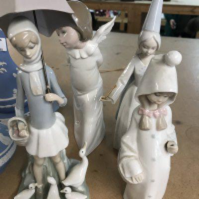 A collection of four Lladro figures .