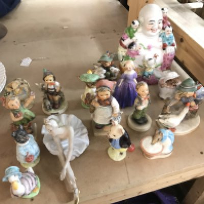 A collection of ceramic figures including Doulton , Goebel and Beswick
