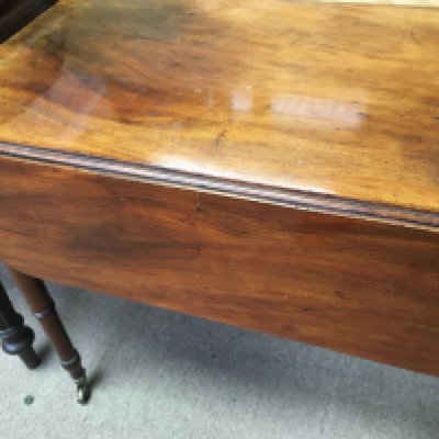 A Georgian mahogany drop leaf table the twin flap top above turned legs . NO RESERVE