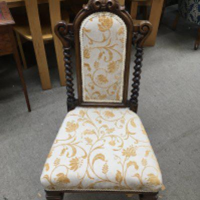 An oak hall seat with a hinged back.